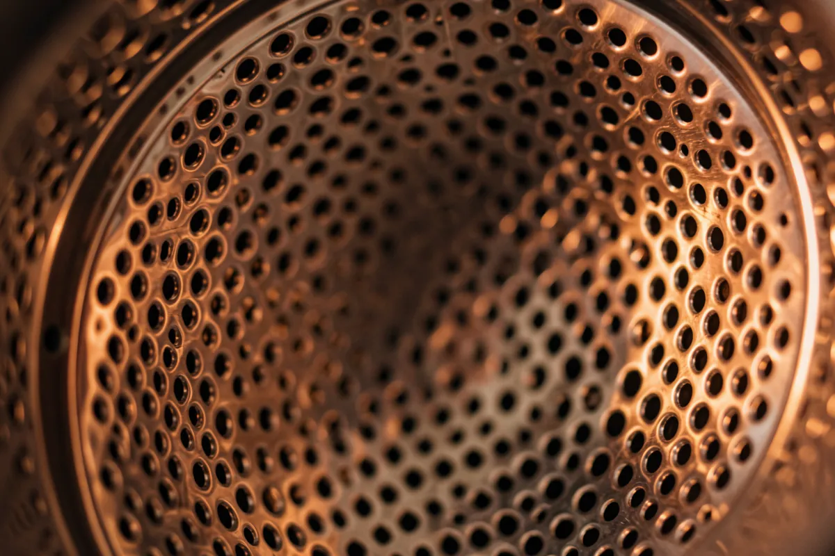 Lähikuva kuivausrummun metallisesta rummusta ja sen pinnasta.